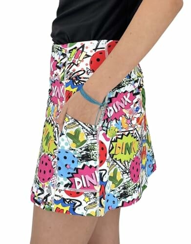 Side view of a colorful comic print skirt with a hand in the pocket.