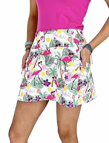 Woman wearing white shorts with colorful flamingo and floral print.