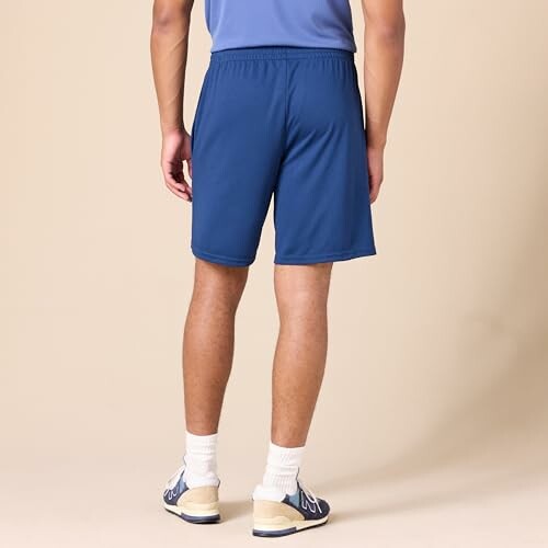 Back view of a man wearing blue shorts and a blue shirt.