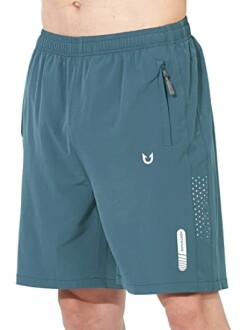 Man wearing blue athletic shorts with zipper pocket.