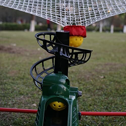 Outdoor ball launcher toy with spiral track and net.