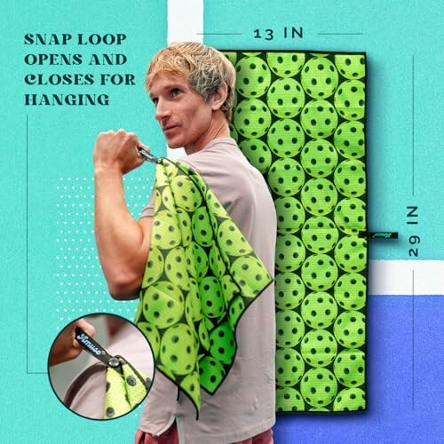 Man holding a green pickleball-themed towel with snap loop for hanging.