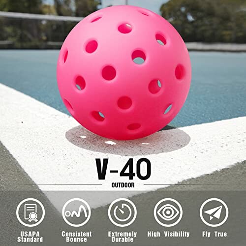 Pink pickleball on outdoor court with V-40 branding