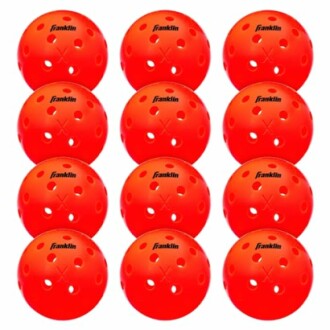 Set of twelve red pickleball balls with holes.