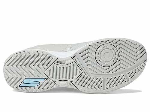 Bottom view of a white sneaker sole with textured pattern